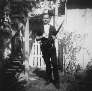 Lee_Harvey_Oswald_with_rifle,_taken_in_Oswald's_back_yard,_Neely_Street,_Dallas_Texas,_March_1963,_CE133A